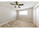 This bedroom includes a ceiling fan, closet, laminate flooring, and neutral paint at 3238 W Rose Ln, Phoenix, AZ 85017
