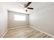 An empty bedroom featuring a ceiling fan, light colored walls and laminate wood flooring at 3238 W Rose Ln, Phoenix, AZ 85017