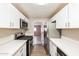 This kitchen features white cabinetry, stainless steel appliances, and light counter tops at 3238 W Rose Ln, Phoenix, AZ 85017
