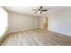 Spacious living room with neutral walls, light wood flooring, and ceiling fan at 3238 W Rose Ln, Phoenix, AZ 85017