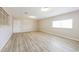 Spacious living room with neutral walls, light wood flooring, and ample natural light at 3238 W Rose Ln, Phoenix, AZ 85017