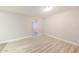Bright, open room featuring light wood flooring, neutral walls, and an open doorway at 3238 W Rose Ln, Phoenix, AZ 85017