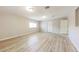 Bright living room with neutral walls, modern wood flooring, and a large window at 3238 W Rose Ln, Phoenix, AZ 85017