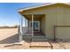 Rear exterior view of the home showing the back porch and deck at 32650 N 223Rd Dr, Wittmann, AZ 85361