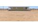 View of the back of the home showing the fence line and the expansive backyard at 32650 N 223Rd Dr, Wittmann, AZ 85361