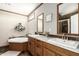 Bright bathroom with dual sinks, framed mirrors and a soaking tub at 32650 N 223Rd Dr, Wittmann, AZ 85361