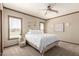 Comfortable bedroom featuring a ceiling fan and a large window for natural light at 32650 N 223Rd Dr, Wittmann, AZ 85361