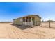 Home exterior featuring a green exterior, covered porch and large yard at 32650 N 223Rd Dr, Wittmann, AZ 85361