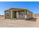 Charming, well-maintained single story home with a cozy front porch and ample natural light at 32650 N 223Rd Dr, Wittmann, AZ 85361