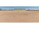 Exterior of the home with large yard and partially fenced perimeter at 32650 N 223Rd Dr, Wittmann, AZ 85361