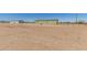 Exterior view of fenced homes with ample land and desert landscaping at 32650 N 223Rd Dr, Wittmann, AZ 85361