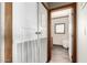 Hallway view showing the utility closet and entry into the adjacent bathroom at 32650 N 223Rd Dr, Wittmann, AZ 85361