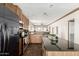 Spacious kitchen equipped with stainless steel appliances, a center island, and dark countertops at 32650 N 223Rd Dr, Wittmann, AZ 85361