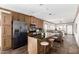Modern kitchen features a center island, stainless steel appliances, and dark countertops at 32650 N 223Rd Dr, Wittmann, AZ 85361