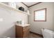Bright laundry room with wood-look floors, natural light, and storage at 32650 N 223Rd Dr, Wittmann, AZ 85361