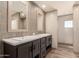 Modern bathroom features a double sink vanity with gray cabinets and elegant tile work at 32712 N 223Rd Dr, Wittmann, AZ 85361
