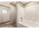 Clean, bright bathroom featuring a modern bathtub and shower combination with a neutral color scheme at 32712 N 223Rd Dr, Wittmann, AZ 85361