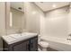 Bathroom with a vanity, toilet, and a tub-shower combo create a functional space at 32712 N 223Rd Dr, Wittmann, AZ 85361