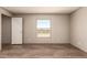 Cozy bedroom with natural light, wood-look flooring, and neutral paint creating a relaxing ambiance at 32712 N 223Rd Dr, Wittmann, AZ 85361