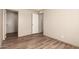 Bedroom with wood-look flooring and a doorway that opens into a closet and hallway at 32712 N 223Rd Dr, Wittmann, AZ 85361