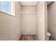 A well-lit closet space with a shelf and wood-look flooring complements the space at 32712 N 223Rd Dr, Wittmann, AZ 85361