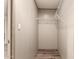 Functional closet space with wood-look floors and metal shelving for organization and storage solutions at 32712 N 223Rd Dr, Wittmann, AZ 85361
