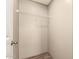Closet features a wire shelf and wood-look flooring, enhancing its overall functionality at 32712 N 223Rd Dr, Wittmann, AZ 85361