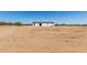 A single-story home with a fenced yard and clear, sunny skies at 32712 N 223Rd Dr, Wittmann, AZ 85361
