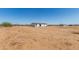 A single-story home with a fenced yard and clear, sunny skies at 32712 N 223Rd Dr, Wittmann, AZ 85361