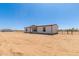 Well-maintained single-story home, featuring a fenced yard, with ample space at 32712 N 223Rd Dr, Wittmann, AZ 85361