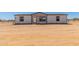 Charming single-story home with white siding, black trim, and a neatly landscaped front yard at 32712 N 223Rd Dr, Wittmann, AZ 85361