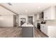 Modern kitchen boasts stainless appliances, a large island, and stylish gray and white finishes at 32712 N 223Rd Dr, Wittmann, AZ 85361