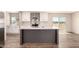 Modern kitchen boasts stainless appliances, a large island, and stylish gray and white finishes at 32712 N 223Rd Dr, Wittmann, AZ 85361