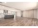 Bright open-concept living room featuring a kitchen island, modern finishes, and stylish wood-look flooring at 32712 N 223Rd Dr, Wittmann, AZ 85361