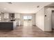 Open-concept area boasts a modern kitchen, wood flooring, and a bright sliding glass door at 32712 N 223Rd Dr, Wittmann, AZ 85361