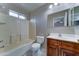 Cozy bathroom featuring a shower-tub combo, toilet, and a vanity with a dark wood cabinet at 42 S Vineyard --, Mesa, AZ 85210