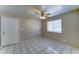A comfortable bedroom with tile floors, a ceiling fan and natural light at 42 S Vineyard --, Mesa, AZ 85210