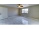Bright bedroom features stylish tile flooring, a ceiling fan, and a window for natural light at 42 S Vineyard --, Mesa, AZ 85210