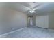 Bright bedroom features stylish tile flooring, a ceiling fan, closet, and neutral walls at 42 S Vineyard --, Mesa, AZ 85210