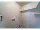 A small walk in closet is painted with white walls and equipped with an electrical outlet at 42 S Vineyard --, Mesa, AZ 85210