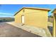 Rear exterior view of the home showing a door and concrete paving at 42 S Vineyard --, Mesa, AZ 85210
