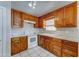 A practical kitchen featuring wooden cabinets and white appliances at 42 S Vineyard --, Mesa, AZ 85210