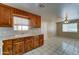 Traditional kitchen featuring wood cabinetry, tiled countertops, and a double basin sink below a window at 42 S Vineyard --, Mesa, AZ 85210