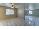Sunlit, open-concept living room with neutral walls, ceiling fans, and tile flooring throughout the space at 42 S Vineyard --, Mesa, AZ 85210