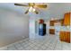 Large open-concept living room with tile floors, flowing into the kitchen at 42 S Vineyard --, Mesa, AZ 85210