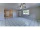 A spacious living room with tile floors, a ceiling fan, and natural light at 42 S Vineyard --, Mesa, AZ 85210