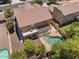 Aerial view of a home with a backyard pool, covered patio, and lush landscaping at 5060 S Clancy --, Mesa, AZ 85212