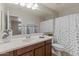 Clean bathroom featuring a single sink vanity, a full mirror, and a shower-tub combo at 5060 S Clancy --, Mesa, AZ 85212