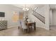 Cozy dining area with neutral tones, elegant chandelier and convenient access to a staircase at 5060 S Clancy --, Mesa, AZ 85212