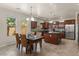 Eat-in kitchen with dark wood cabinetry, stainless steel appliances, and granite countertops at 5060 S Clancy --, Mesa, AZ 85212